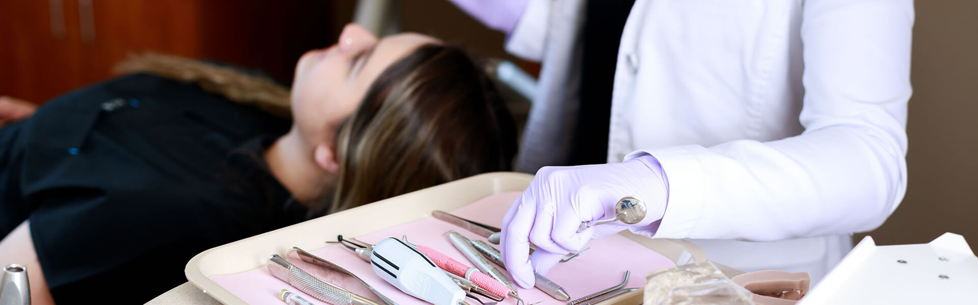 Dental instruments on tray with patient, Lake Five Dentistry Colgate WI.
